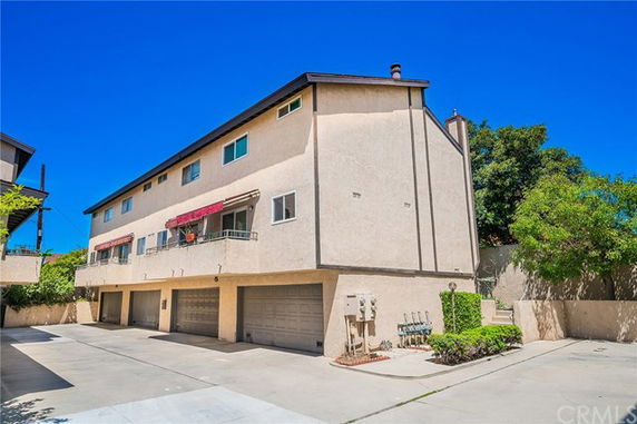 Front view of a multi-story residential building with garages.