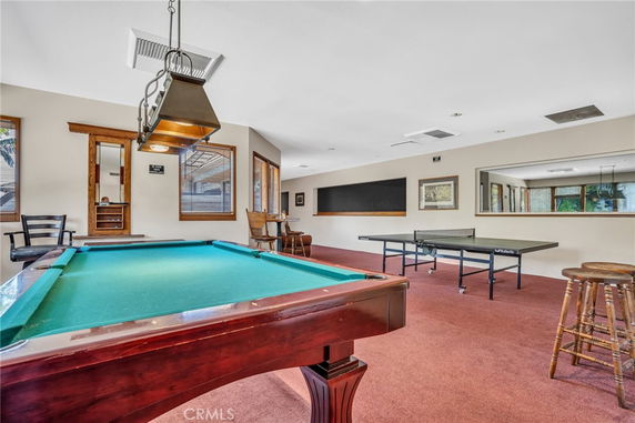 Indoor recreation room with a pool table and table tennis.