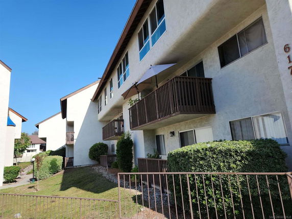 View of a multi-story apartment building with balconies.
