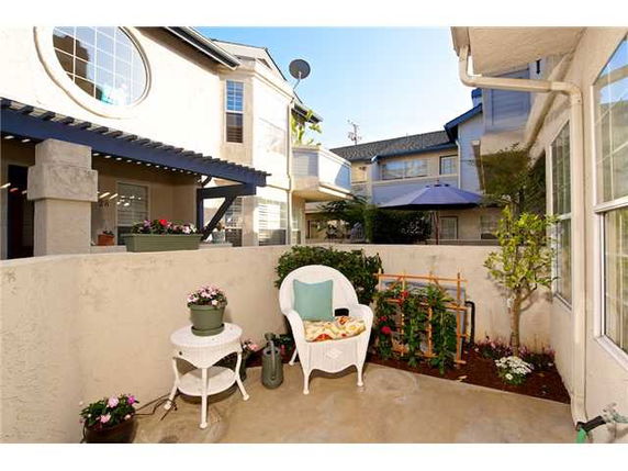 View of apartment buildings with a small patio area in the foreground.