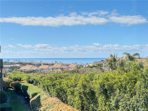 Panoramic view of houses with ocean in the background.