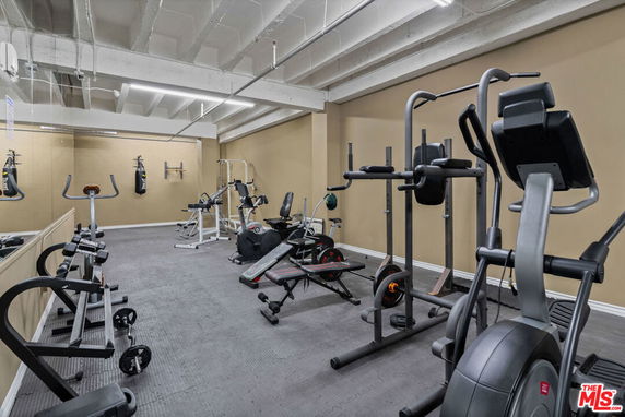 Indoor gym area with various exercise equipment and weights