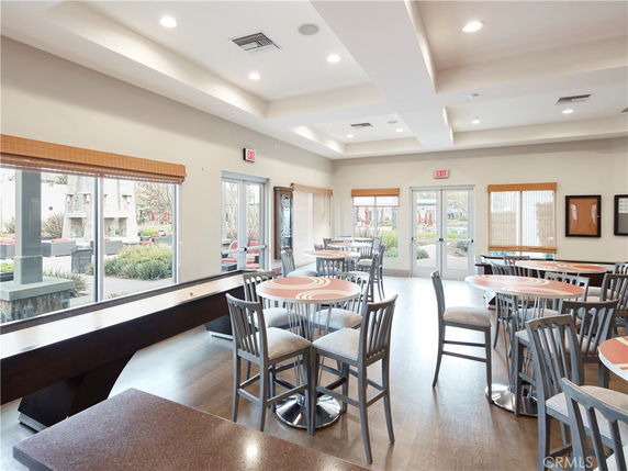 Interior view of a recreational clubhouse with tables and chairs.