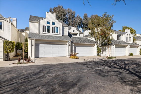 Front view of a multi-story house with a double garage.
