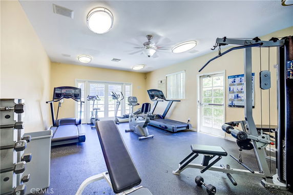 Indoor gym area with exercise equipment including treadmills and weight machines.