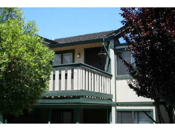 Front view of a house with wooden balcony.