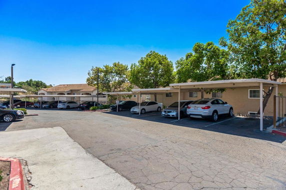 Outdoor parking area with covered parking spaces.