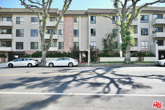 Front view of a multi-story residential building with balconies.