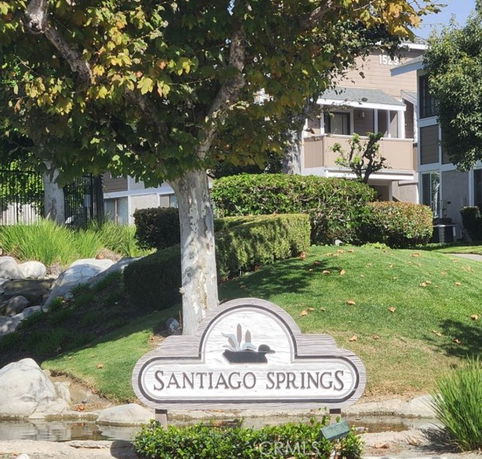 Front view of a multi-story residential building with a sign reading 'Santiago Springs'.