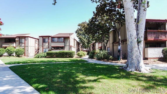 Front view of a residential apartment complex with multiple two-story buildings.