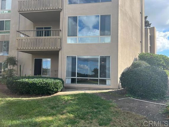 Front view of a multi-story building with balconies.