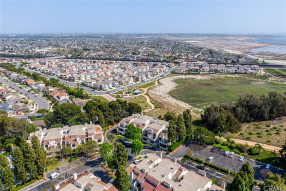 Panoramic aerial view of a residential area with houses and surrounding landscape.