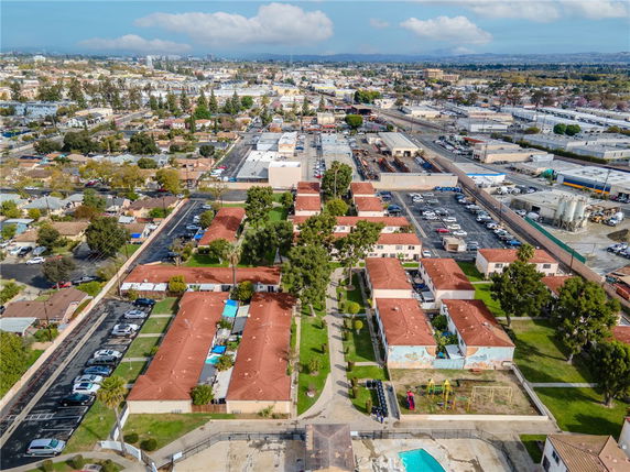 Aerial view of a residential area with multiple buildings and parking spaces.
