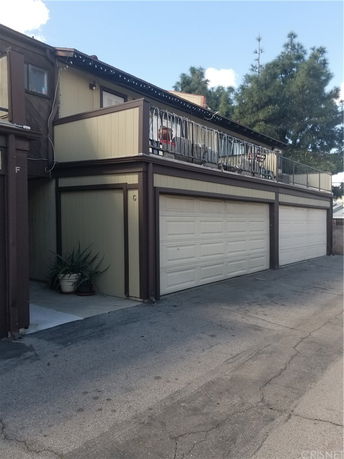 Front view of a two-story building with garage doors on the ground level.