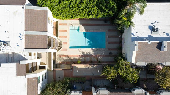 Aerial view of a swimming pool area between buildings.