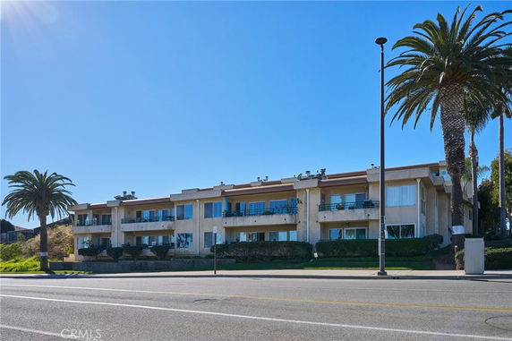 Front view of a two-story apartment building with balconies.