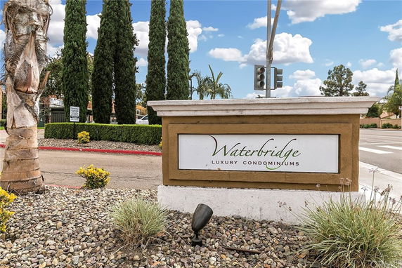 Sign for Waterbridge Luxury Condominiums near a street intersection