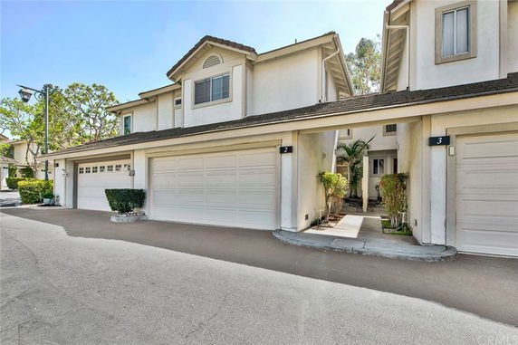 Front view of a two-story building with a double garage