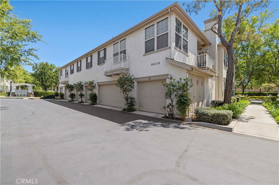 Front view of a two-story residential building with attached garages.