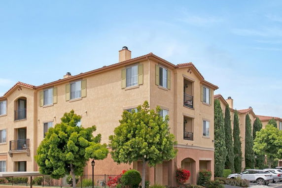 Front view of a multi-story apartment building with balconies.