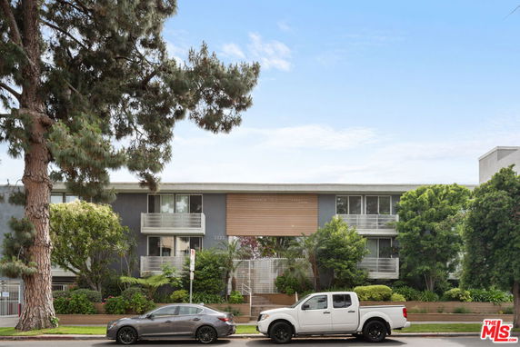 Front view of a two-story apartment building with balconies.