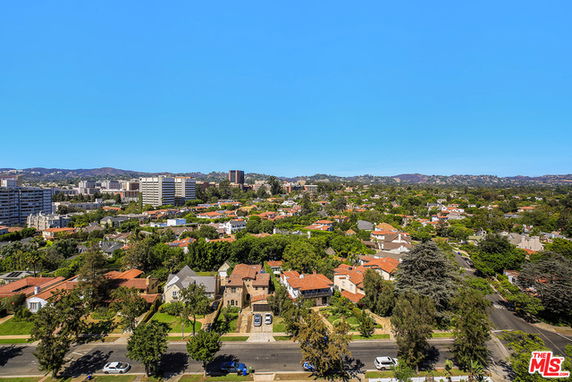 Panoramic view of a cityscape with residential and commercial buildings.