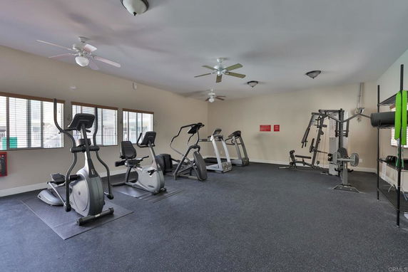 Exercise room with several stationary bikes and fitness equipment.