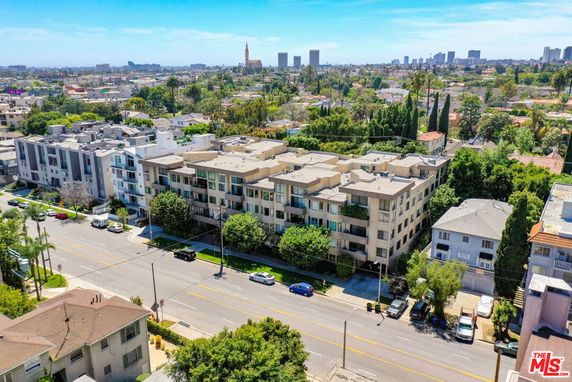 Aerial view of a residential area with multiple buildings and greenery.