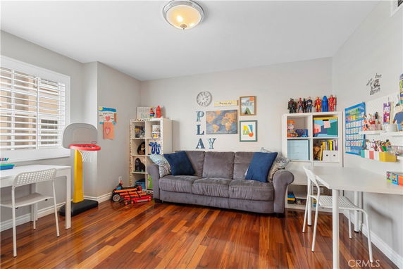 Room with toys, a small basketball hoop, and decorations for children's play.