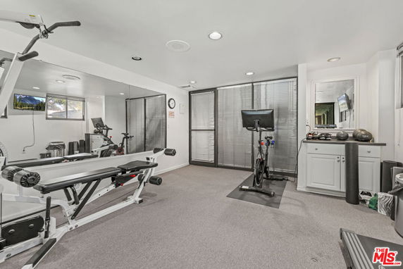 Indoor gym area with exercise equipment and mirrors