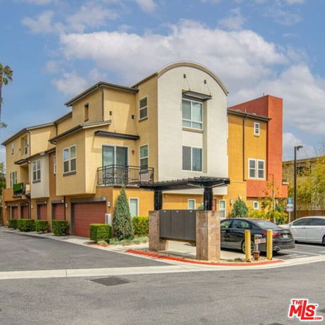 Front view of a multi-story apartment building with a modern design.