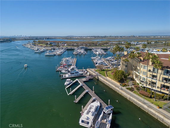 Panoramic view of marina with boats and nearby buildings.