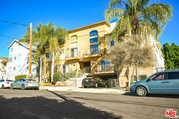Front view of a multi-story residential building with balconies.