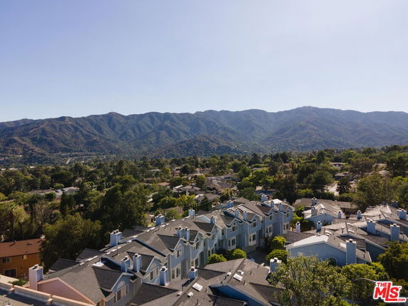 Wide angle view of residential area with mountains in the background.
