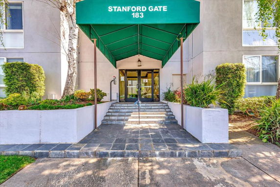 Front view of a building entrance with a green canopy labeled 'Stanford Gate 183.'
