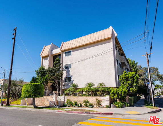 Front view of a multi-story building with a sloped roof.