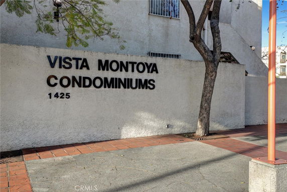Front view of Vista Montoya Condominiums building with signage.
