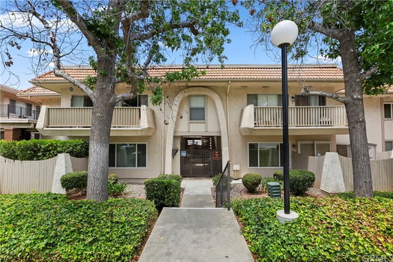 Front view of a two-story apartment building with balconies.