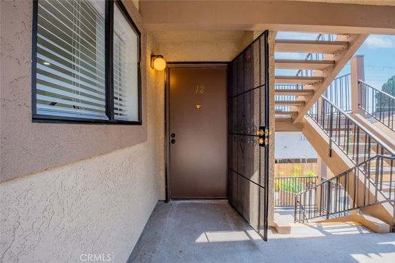Exterior view of an apartment door with stairs.