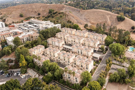Aerial view of a residential complex with multiple buildings and surrounding greenery.