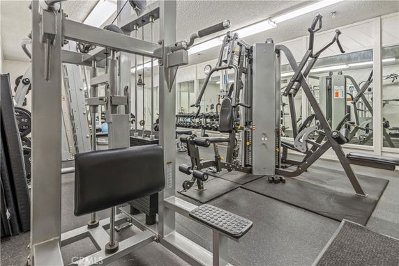 Indoor gym area with various exercise machines and equipment.