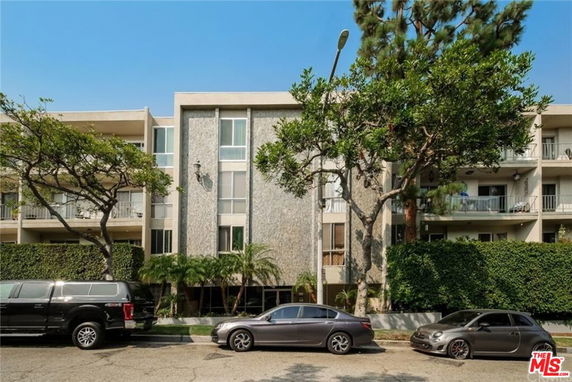 Front view of a multi-story residential building with balconies.