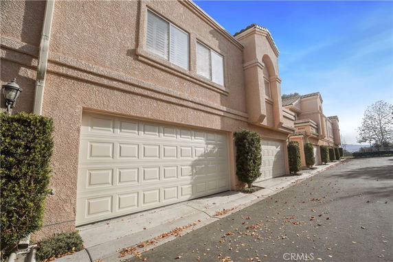 Front view of a row of attached garages in a residential building.