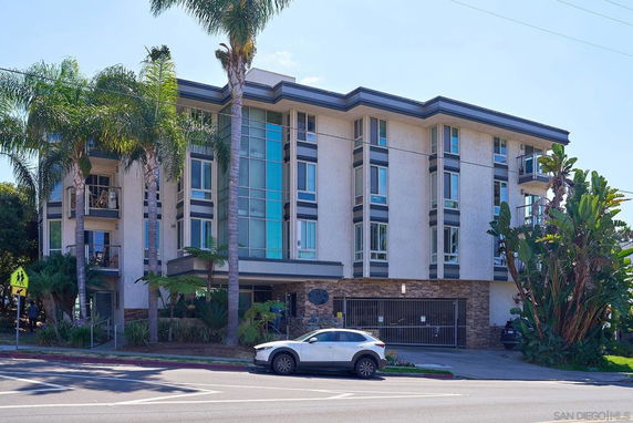 Front view of a multi-story apartment building with a contemporary design.