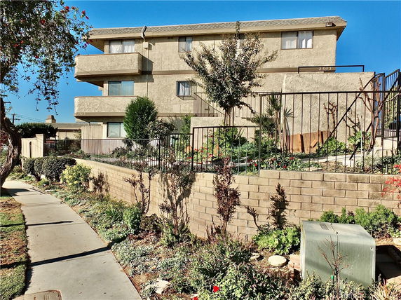 Front view of a multi-story residential building with balconies.