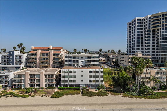 Front view of beachfront apartment buildings with balconies.