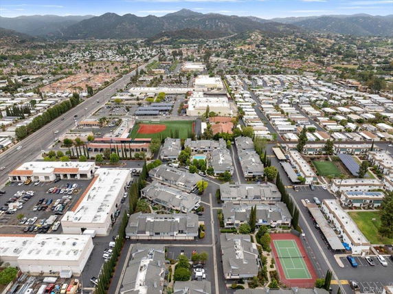 Panoramic view of a residential and commercial area with mountains in the background.