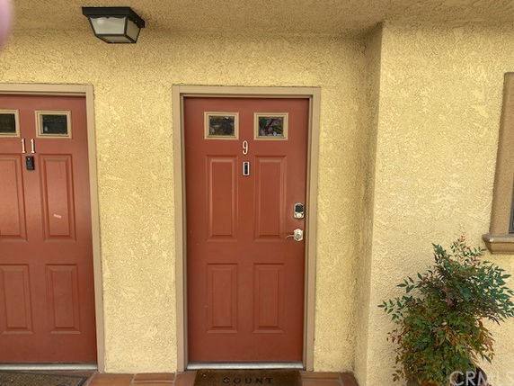 Front view of a building with two red doors, numbered 9 and 11.