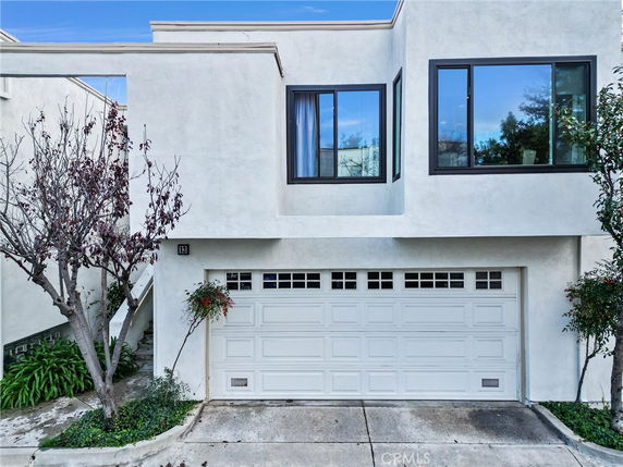 Front view of a modern two-story house with a double garage.