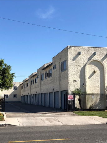 Front view of a multi-story residential building with multiple garages.